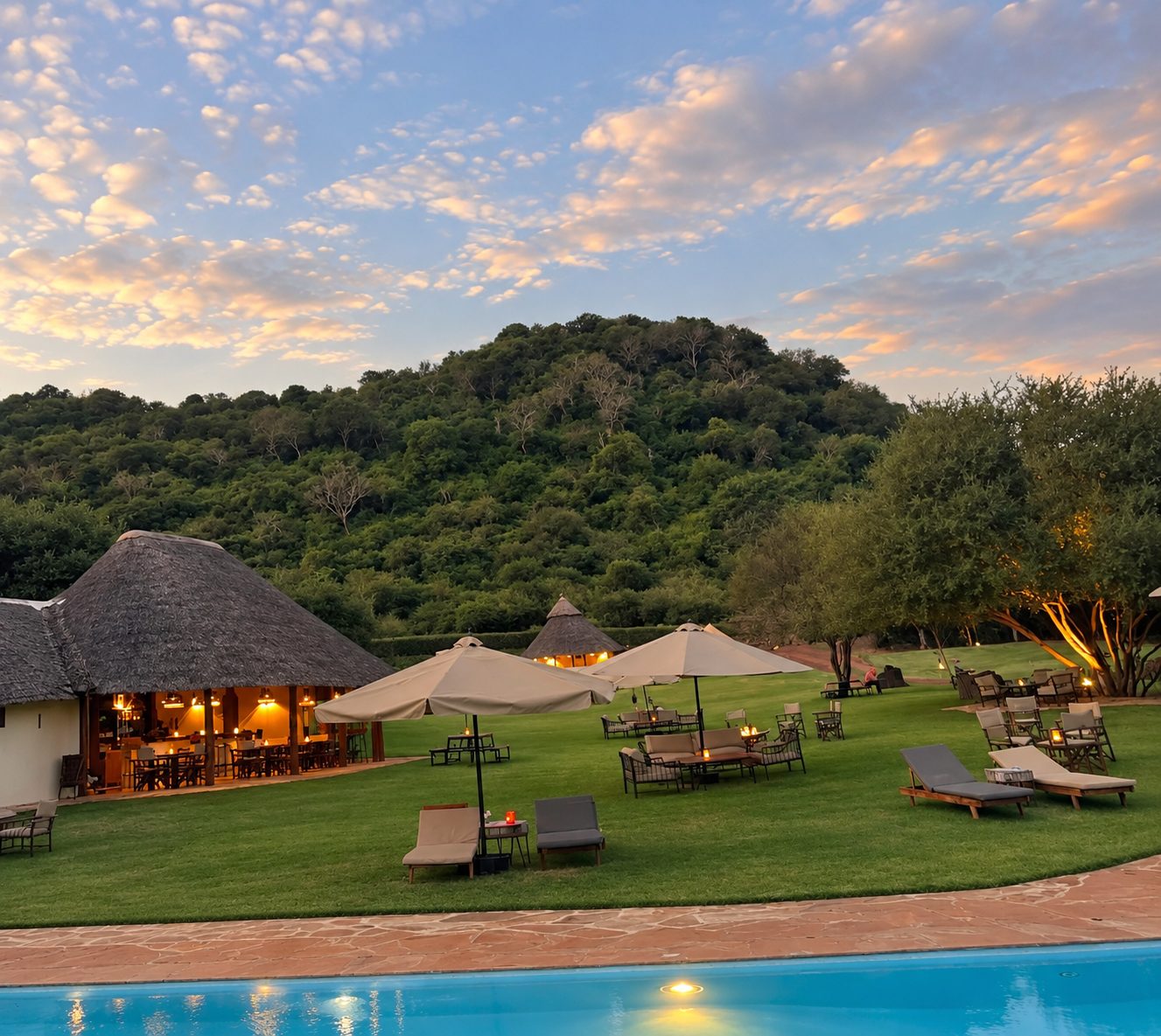 Restaurant and lawn at dusk beside the pool