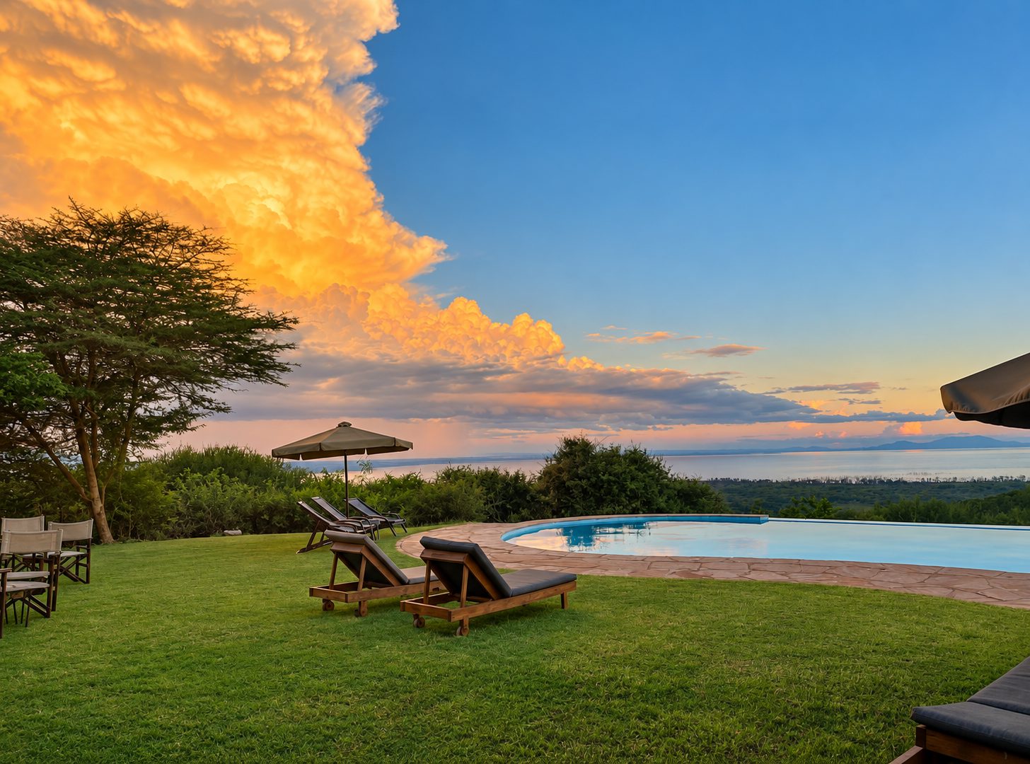 Infinity pool and sun loungers at sunset