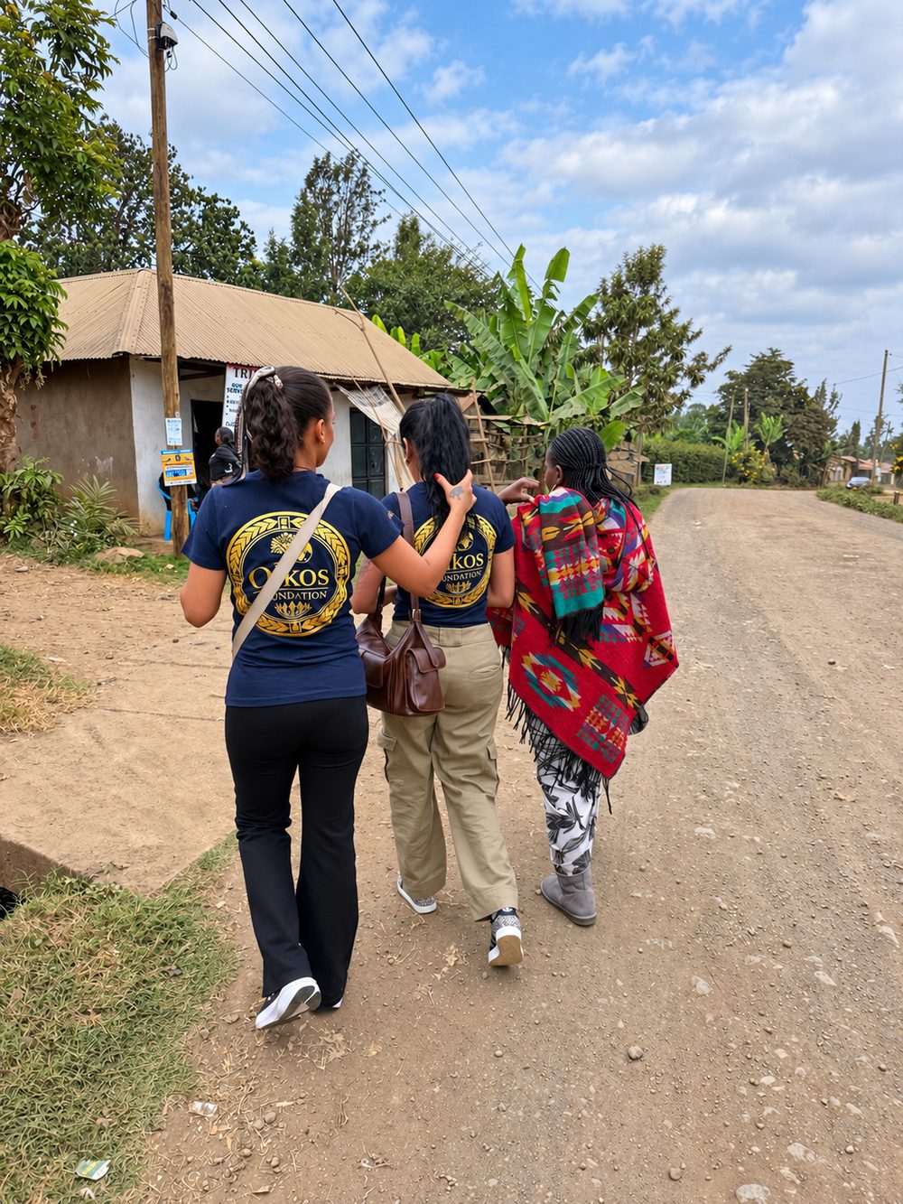 Volunteers walking with a local woman along a village road